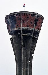 Vukovar water tower during the Siege of Vukovar in eastern Croatia, 1991. The tower came to symbolize the town's resistance to Serb forces. Vukovar water tank.jpg