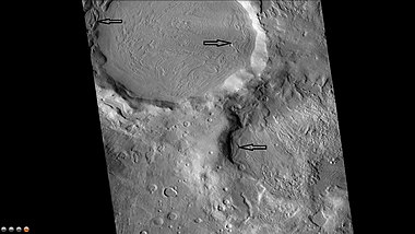 Northeast rim of Quenisset Crater, as seen by CTX camera (on Mars Reconnaissance Orbiter). Note: this is an enlargement of the previous image of Quenisset Crater. Arrows indicate old glaciers.