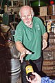 A tour guide at the Black Sheep Brewery distributes a sample of "Monty Python's Holy Grail Ale".