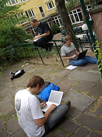 Three MediaWiki developers programming at Wikimania.