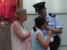 A woman asking a Hong Kong policeman for directions. HK police officer.JPG