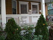 Picture of a porch, including a railing, and columns
