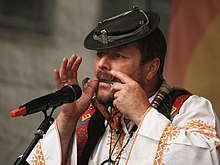 Man playing the Slovak drumbla Prazsky jarmark 365.jpg