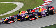 Sebastian Vettel passing teammate Mark Webber