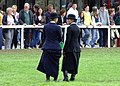 Two judges at a horse show in Dublin Ireland wearing correct modern riding habits.