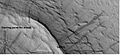 Dark slope streaks and layers near a pedestal crater, as seen by HiRISE under the HiWish program. Layers were protected by the top of the pedestal crater. Image in Arabia quadrangle.