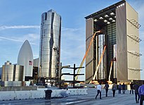 Photograph of many steel spacecraft inside and outside the building