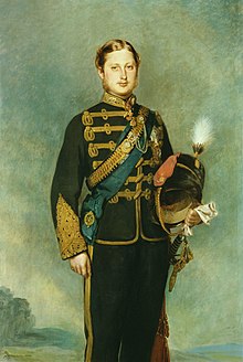 Old painting of a young man facing us, in a military uniform and sword, holding his helmet and wearing many decorations and two sashes across his chest