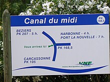"You are here" sign on the Canal du Midi just before the turn onto La Nouvelle branch. Locations on this French canal are marked in PK (point kilometre) values. Canal du Midi & Canal de Jonction sign (Gloverepp).JPG