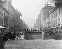 A more solid barricade on Main Street using construction materials from a nearby site