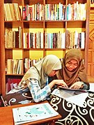 Two community members discuss in library room