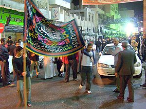 A banner (aalam) being carried in a procession...