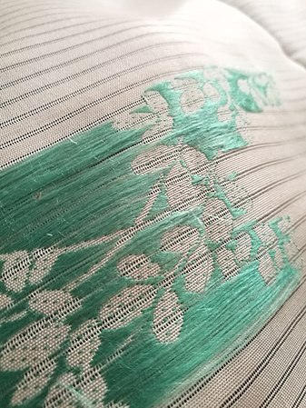 Reverse view of flat silk embroidery on ro weave