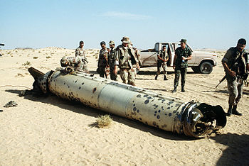 English: Military personnel examine a Scud mis...