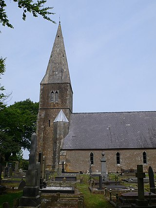 A church with narrow windows, a steeply pitched slate roof and a steeple.