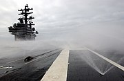 The counter-measure wash-down system of Ronald Reagan being tested. This is part of the ship's defense against chemical, biological or radiological threats, and also against fires US Navy 050615-N-8148A-063 The Nimitz-class aircraft carrier USS Ronald Reagan (CVN 76) activates her countermeasures wash down system as part of a series of test and evaluations to certify the vessel in the event of a chemical.jpg