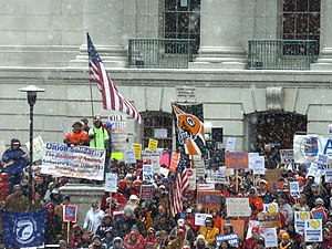 Demonstrators in steadily falling snow outside of the Wisconsin Capitol building 2011 Wisconsin Budget Protests 2 JO.jpg