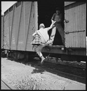 Freight-hopping youth near Bakersfield, California (National Youth Administration, 1940) Bakersfield, California. On the Freights. Helping a newcomer hop a freight - NARA - 532069.tif