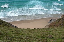 Water waves are almost parallel to the beach when they hit it because they gradually refract towards land as the water gets shallower. Beach and waves (2784111859).jpg