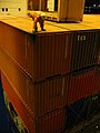 90px-Dockworker_on_a_high_stack_of_containers
