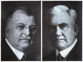 man with glasses and mustache on left and white-haired man on right