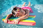 This swimming board is made of polystyrene,it is an example of a polymer. Girl with swimming board.jpg