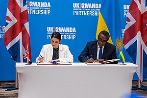 British home secretary Priti Patel (left) and Rwandan foreign minister Vincent Biruta (right) sign the policy on 14 April 2022 Home Secretary - Rwanda Visit.jpg