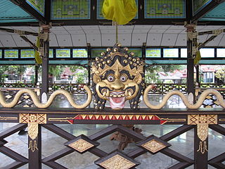 Ornate railing with a mask