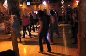 Line dancing at a Country Western Dance Hall a...
