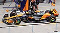 Oscar Piastri's MCL38 displayed in the pit lane at the Chinese Grand Prix.