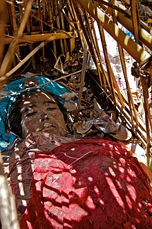 The body of a young lady inside a bamboo cage is left to decompose.