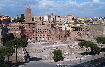 Trajan's Forum and Market with the Angelicum campus in distance at center including the Church of Saints Dominic and Sixtus. The Torre delle Milizie can be seen to the left of campus. Trajan Forum.jpg