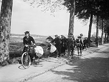 Belgian civilians fleeing westwards away from the advancing German army, 12 May 1940 British troops and Belgian refugees on the Brussels-Louvain road, 12 May 1940. F4422.jpg