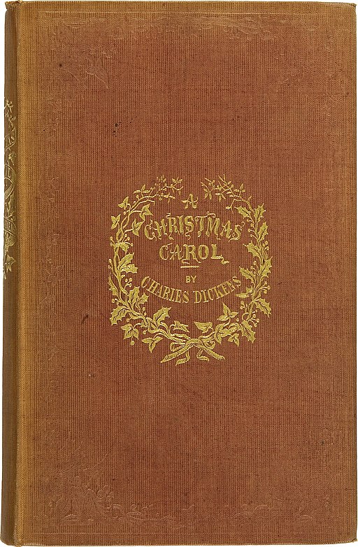 Brown book stay on bearing a words "A Christmas Carol by Charles Dickens" in gold.