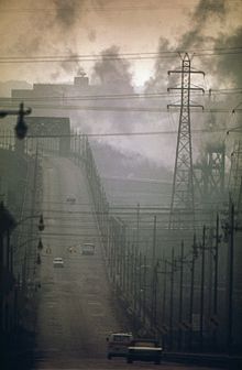 Air pollution in the US, 1973 DARK CLOUDS OF FACTORY SMOKE OBSCURE CLARK AVENUE BRIDGE - NARA - 550179.jpg