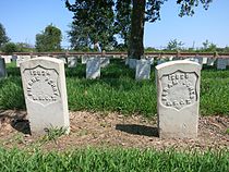 Photo shows the graves of Pierre Perry and Abram Jones, US Colored Troops, at the Chalmette National Cemetery in New Orleans.