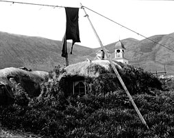 Barabaras in Karluk, Alaska with steeple in background