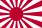 A flag bearing a stylised red sunburst symbol on a white background.