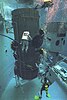 Astronauts practice a Hubble Space Telescope repair in the Neutral Buoyancy Simulator.