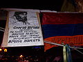 Portrait of Serhiy Nigoyan with the flag of Armenia at the gates of barricade No 32.