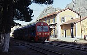 Thessaly Metre gauge system in central Greece from Volos to Kalabáka (or Kalambaka) was covered during a visit to the country in November 1992. Having spent the night here, the first move on 7 November 1992 was retracing our route as far as the junction station of Paleofarsalos. Seen here is German-built 2-car DMU no. A.6522 on train 1845, 09:40 Kalambaka to Volos. Note the rock formations in the background, which are a major tourist attraction in the area.