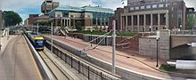 A Green Line train after leaving the East Bank Station, heading towards Downtown Minneapolis Green Line, Coffman Union, and bus stop.jpg