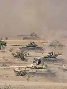 Indian Army T-90 Bhishma tanks take part in a military training exercise in the Thar Desert, Rajasthan. The tanks have two different turret armor arrays. IA T-90 in action.jpg