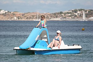 English: Womand and child on a pedalo with sli...