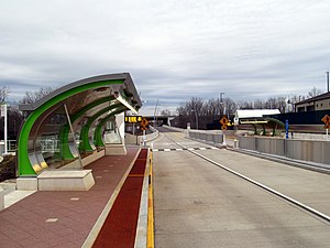 A bus station platform with a curved canopy