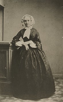 Photograph of Henriette Renan standing in 19th-century costume