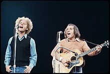 Art Garfunkel and Paul Simon singing on stage at the Madison Square Garden in 1972.