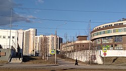 Воркутинская улица с памятным знаком горнякам Воркуты на стене парковки