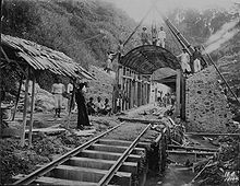 Workers pose at the site of a railway tunnel under construction in the mountains, 1910. COLLECTIE TROPENMUSEUM Arbeiders poseren bij een in aanbouw zijnde spoorwegtunnel in de bergen TMnr 60047638.jpg