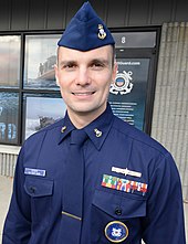 U.S. Coast Guard garrison cap, as worn by a chief petty officer with the winter dress blue uniform Chief Petty Officer Nick Scheck stands in front of Coast Guard Recruiting Office Atlantic City, New Jersey.jpg
